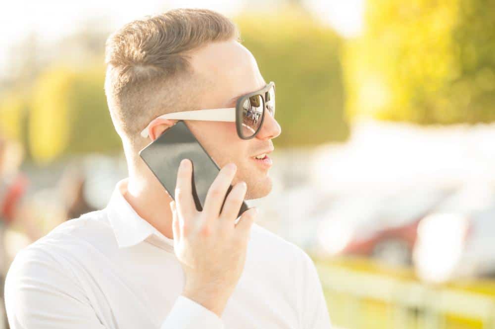 man talking and listening on cell phone