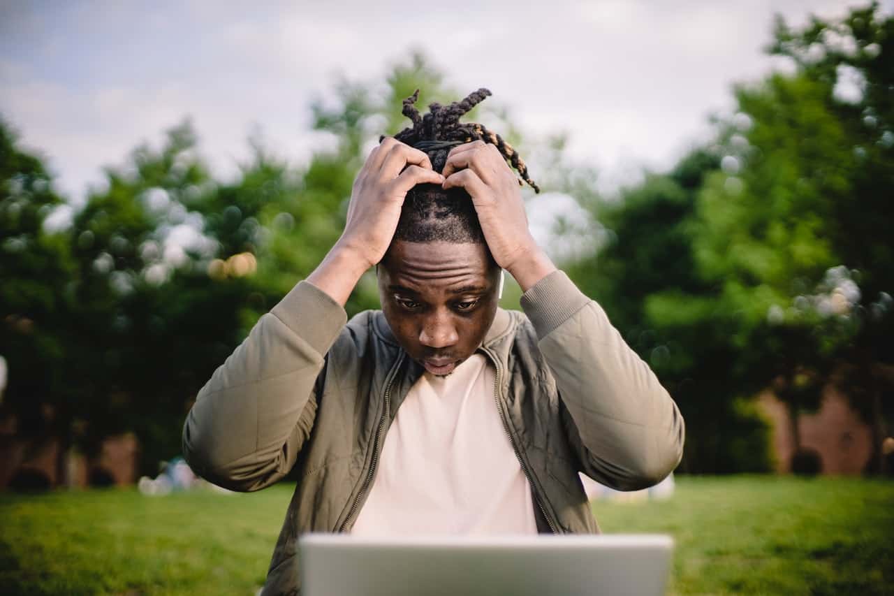 overworked man pulling at his hair